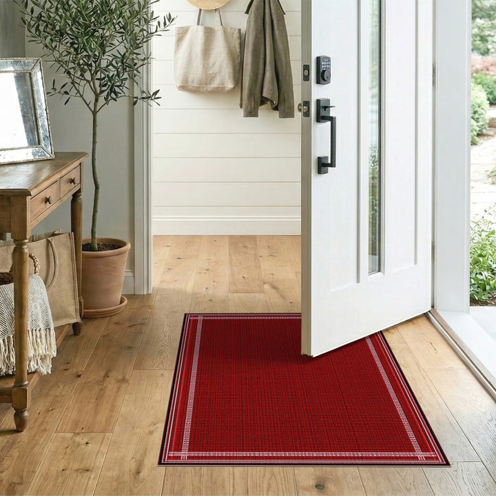 Red Area Rug with White Geometric Border